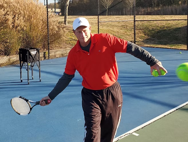Mark Posta in action on the court, demonstrating a forehand