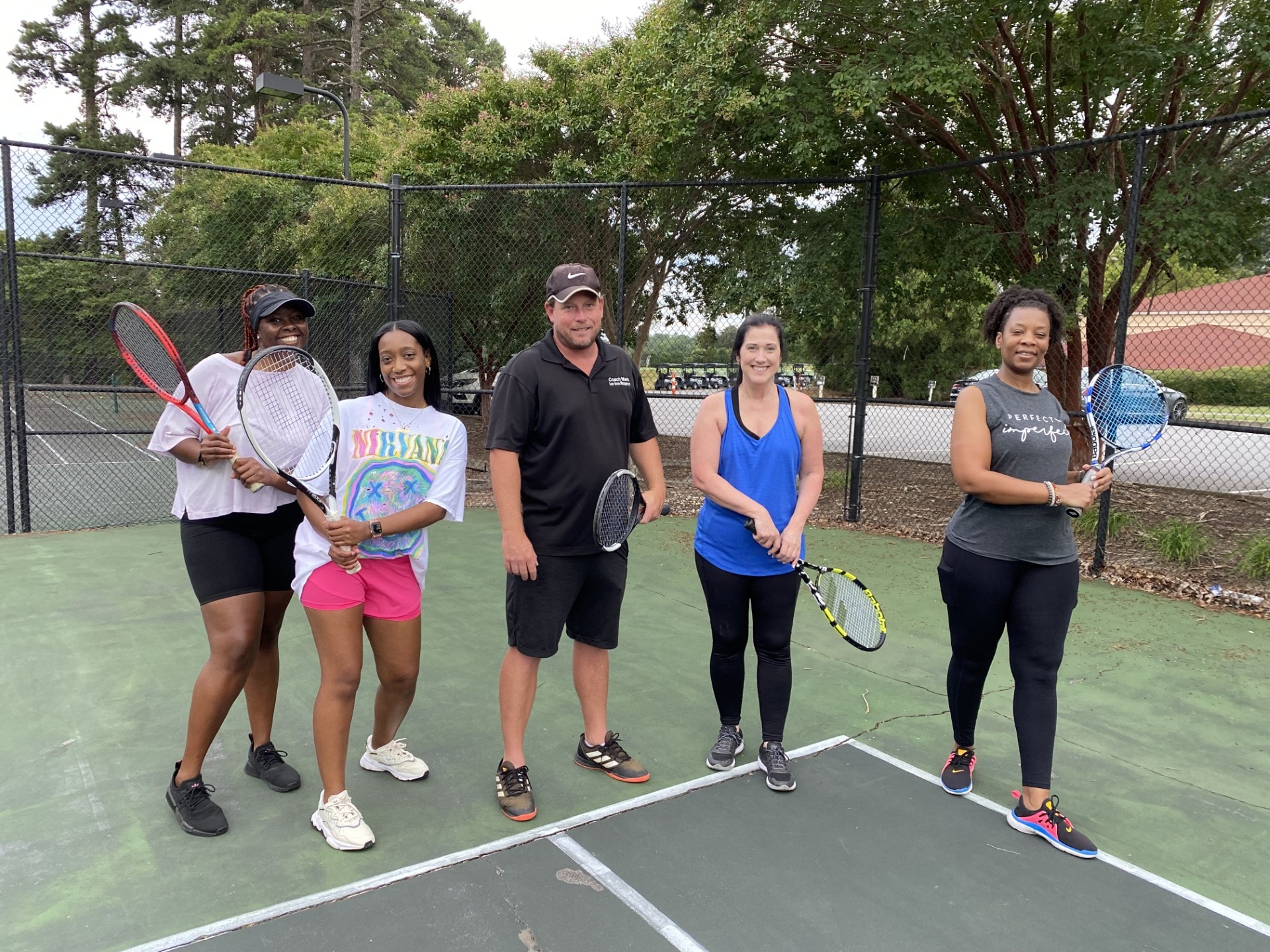 Mark with a group of adult women players at an outdoor clinic